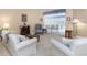 Relaxing living room featuring ample seating, a fireplace, and sunlit windows for a comfortable space at 8514 Ashbury Dr, Hudson, FL 34667