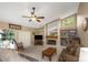 Bright living room boasts a fireplace, built-in shelving, and views of the pool area at 8514 Ashbury Dr, Hudson, FL 34667