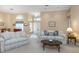 Bright living room with neutral walls, stylish couches, and arched windows at 8514 Ashbury Dr, Hudson, FL 34667