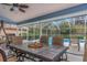 Covered lanai featuring outdoor dining area with a view of the screened pool and backyard at 8514 Ashbury Dr, Hudson, FL 34667
