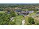 An aerial view of a golf course and tennis courts showcasing the community's recreational amenities at 888 Royal Birkdale Dr, Tarpon Springs, FL 34688