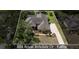Aerial view of a home with a screened in pool and spa, surrounded by lush landscaping and mature trees at 888 Royal Birkdale Dr, Tarpon Springs, FL 34688