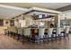 Stylish bar area with wood accents, pendant lighting, and comfortable seating creates a relaxing ambiance for socializing at 888 Royal Birkdale Dr, Tarpon Springs, FL 34688