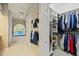The bathroom features a soaking tub, custom window and a walk-in closet with custom shelving at 888 Royal Birkdale Dr, Tarpon Springs, FL 34688