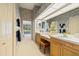 Bathroom featuring double vanity, a stained glass window, and access to the swimming pool at 888 Royal Birkdale Dr, Tarpon Springs, FL 34688