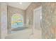 Bright bathroom featuring a soaking tub with a custom stained glass window and a separate shower at 888 Royal Birkdale Dr, Tarpon Springs, FL 34688