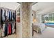 The walk-in closet offers great storage and connects to the bedroom which overlooks the pool at 888 Royal Birkdale Dr, Tarpon Springs, FL 34688