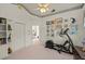 Large bedroom with exercise equipment, built in shelving, and neutral carpets at 888 Royal Birkdale Dr, Tarpon Springs, FL 34688