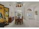 Formal dining room with chandelier and decor, with access to the home's entrance at 888 Royal Birkdale Dr, Tarpon Springs, FL 34688