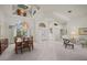 Elegant dining room featuring a large window, chandelier, and neutral-toned decor at 888 Royal Birkdale Dr, Tarpon Springs, FL 34688