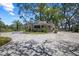 Elegant gated community entrance featuring a charming guardhouse and meticulously landscaped surroundings at 888 Royal Birkdale Dr, Tarpon Springs, FL 34688