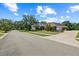 Lovely home featuring a three car garage, brick exterior, and well-manicured landscaping at 888 Royal Birkdale Dr, Tarpon Springs, FL 34688