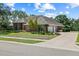 Lovely home featuring a three car garage, brick exterior, and well-manicured landscaping at 888 Royal Birkdale Dr, Tarpon Springs, FL 34688