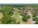Elevated aerial view of a verdant golf course featuring a serene pond and meticulously maintained greens at 888 Royal Birkdale Dr, Tarpon Springs, FL 34688