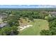 Aerial view of a golf course with sand traps, walking paths and lush trees at 888 Royal Birkdale Dr, Tarpon Springs, FL 34688