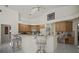 Kitchen with breakfast bar and stylish chairs overlooking the living area at 888 Royal Birkdale Dr, Tarpon Springs, FL 34688