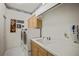 Laundry room with a sink, cabinets, and modern washer and dryer units at 888 Royal Birkdale Dr, Tarpon Springs, FL 34688
