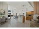 Bright, open-concept living and kitchen area with tile floors, fireplace, and modern appliances at 888 Royal Birkdale Dr, Tarpon Springs, FL 34688