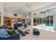 Open-concept living room with a view of the kitchen and screened-in pool area at 888 Royal Birkdale Dr, Tarpon Springs, FL 34688