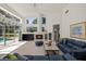 Bright living room featuring vaulted ceiling, large windows, and cozy fireplace at 888 Royal Birkdale Dr, Tarpon Springs, FL 34688