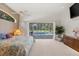 Bright main bedroom with pool view, ceiling fan, and en suite bathroom at 888 Royal Birkdale Dr, Tarpon Springs, FL 34688