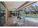 Inviting patio with a table and chairs, offering a comfortable outdoor space with a view of the pool at 888 Royal Birkdale Dr, Tarpon Springs, FL 34688
