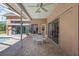 Covered outdoor patio with brick pavers, ceiling fan, and table with chairs at 888 Royal Birkdale Dr, Tarpon Springs, FL 34688