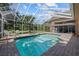 Relax in this screened-in pool, perfect for hot summer days, with an attached spa for ultimate comfort at 888 Royal Birkdale Dr, Tarpon Springs, FL 34688