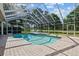Enjoy this screened-in pool with brick pavers and outdoor seating, perfect for relaxing and entertaining at 888 Royal Birkdale Dr, Tarpon Springs, FL 34688