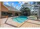 Enjoy the backyard pool and spa combo, complete with a screened enclosure and brick pavers at 888 Royal Birkdale Dr, Tarpon Springs, FL 34688