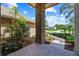 Inviting portico with brick columns, leading to the home's entrance, surrounded by lush landscaping at 888 Royal Birkdale Dr, Tarpon Springs, FL 34688