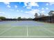 Well-maintained outdoor tennis courts with vibrant green and blue surfaces, and clear white lines at 888 Royal Birkdale Dr, Tarpon Springs, FL 34688