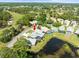 Aerial view of home featuring screened-in pool and views of multiple ponds and golf course at 9010 Penelope Dr, Weeki Wachee, FL 34613