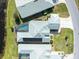 Detailed aerial view of a home with a screened pool, solar panels and manicured landscaping at 9010 Penelope Dr, Weeki Wachee, FL 34613