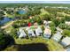 Aerial view of home featuring screened-in pool and views of multiple ponds and golf course at 9010 Penelope Dr, Weeki Wachee, FL 34613