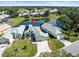 Aerial view of a home with a pond, pool and a well-manicured lawn in a quiet neighborhood at 9010 Penelope Dr, Weeki Wachee, FL 34613