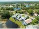 Aerial view of home featuring screened-in pool and views of multiple ponds and golf course at 9010 Penelope Dr, Weeki Wachee, FL 34613