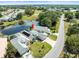 Aerial view of a well-maintained single-Gathering home next to a pond with a screened in pool at 9010 Penelope Dr, Weeki Wachee, FL 34613