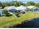 Charming backyard boasts a screened pool and a tranquil pond backdrop, ideal for outdoor enjoyment at 9010 Penelope Dr, Weeki Wachee, FL 34613