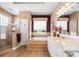 Bathroom featuring walk-in shower, bathtub, and double sink vanity at 9010 Penelope Dr, Weeki Wachee, FL 34613