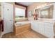 Bathroom with tub, walk-in shower, and vanity at 9010 Penelope Dr, Weeki Wachee, FL 34613