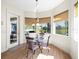 Bright breakfast nook with glass table, pendant lighting, and view of lanai at 9010 Penelope Dr, Weeki Wachee, FL 34613
