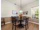 Charming dining space with a round table, four chairs, and a view to a window, complemented by crown molding at 9010 Penelope Dr, Weeki Wachee, FL 34613