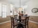 Lovely dining area with a round table and views to multiple rooms featuring crown molding and a pendant light at 9010 Penelope Dr, Weeki Wachee, FL 34613