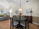 Dining area with a round wood table, upholstered chairs, and a stylish pendant light, perfect for Gathering meals at 9010 Penelope Dr, Weeki Wachee, FL 34613