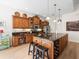 Spacious kitchen featuring a large island with seating, stainless steel appliances, and dark granite countertops at 9010 Penelope Dr, Weeki Wachee, FL 34613