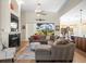 Comfortable living area with fireplace, large windows, and easy access to the outdoor patio at 9010 Penelope Dr, Weeki Wachee, FL 34613