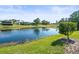 Scenic view of a pond with lush greenery and surrounding homes in a peaceful neighborhood at 9010 Penelope Dr, Weeki Wachee, FL 34613