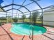 Screened-in pool features brick patio, water features, and view at 9010 Penelope Dr, Weeki Wachee, FL 34613