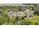 Overhead view of a home with a screened pool in a large lot, surrounded by lush greenery at 9088 Gallup Cir, Spring Hill, FL 34608